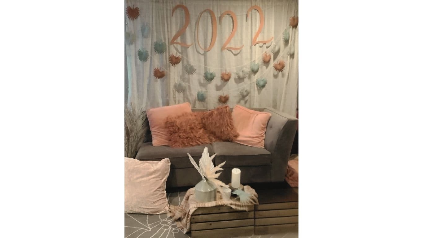 New Year's Eve lounge area with backdrop and rose gold accents by EC Collective