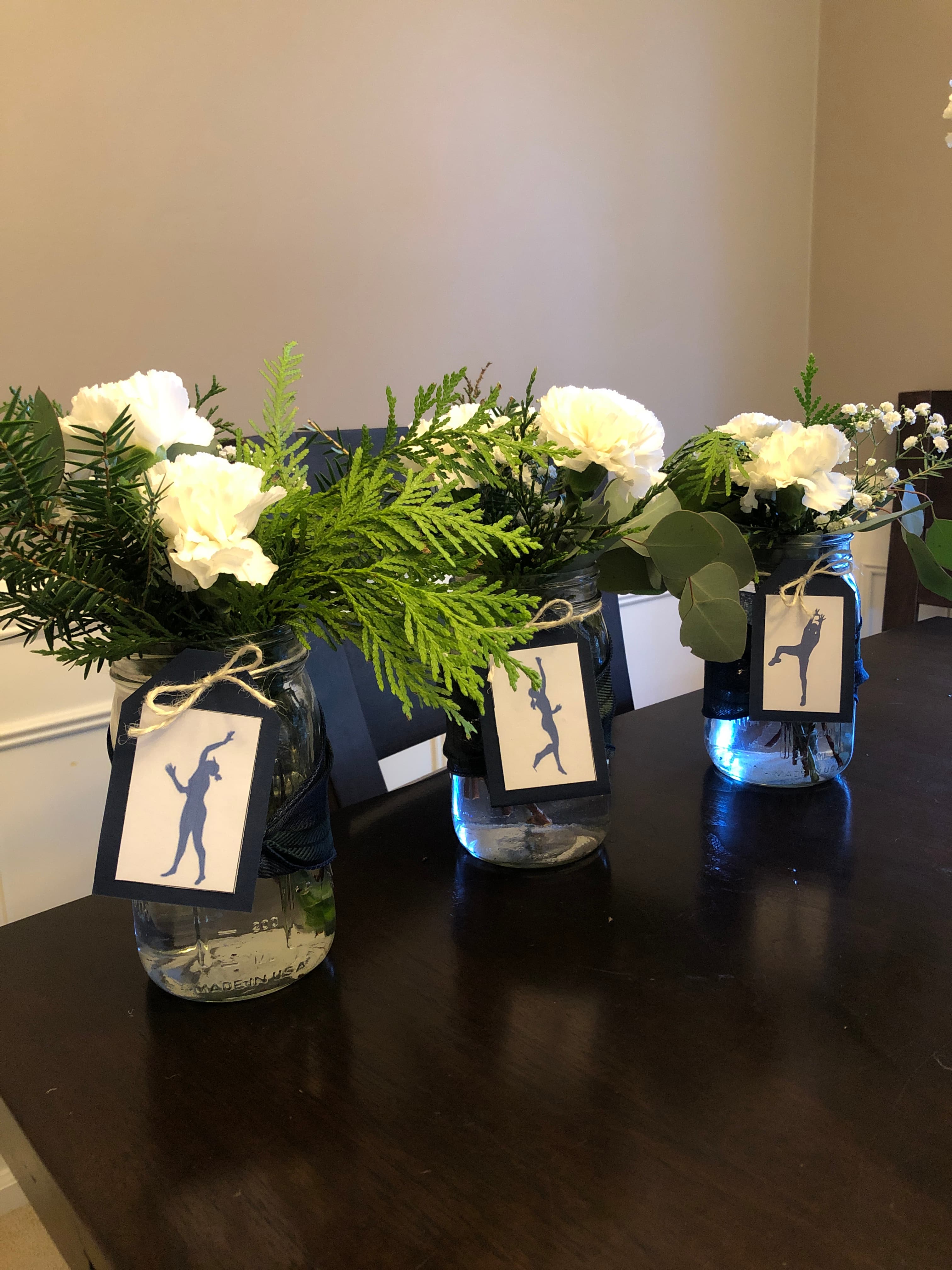Mason jar centerpieces with white florals and greenery styled by EC Collective